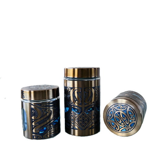 Three gold canisters with Māori design Labelled Ti, Kawhe, Huka -Back image