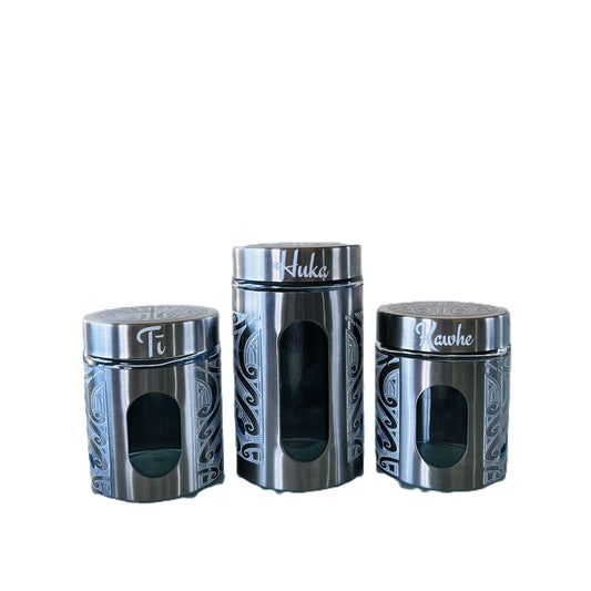 Three silver canisters with Māori design Labelled Ti, Kawhe, Huka 