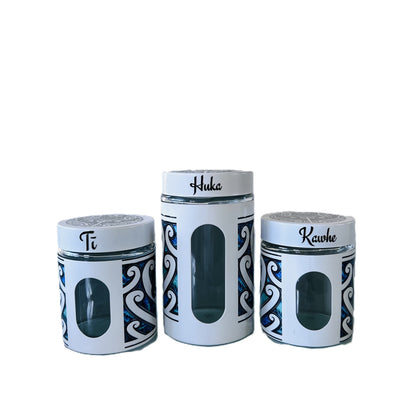 Three white canisters with Māori design Labelled Ti, Kawhe, Huka 
